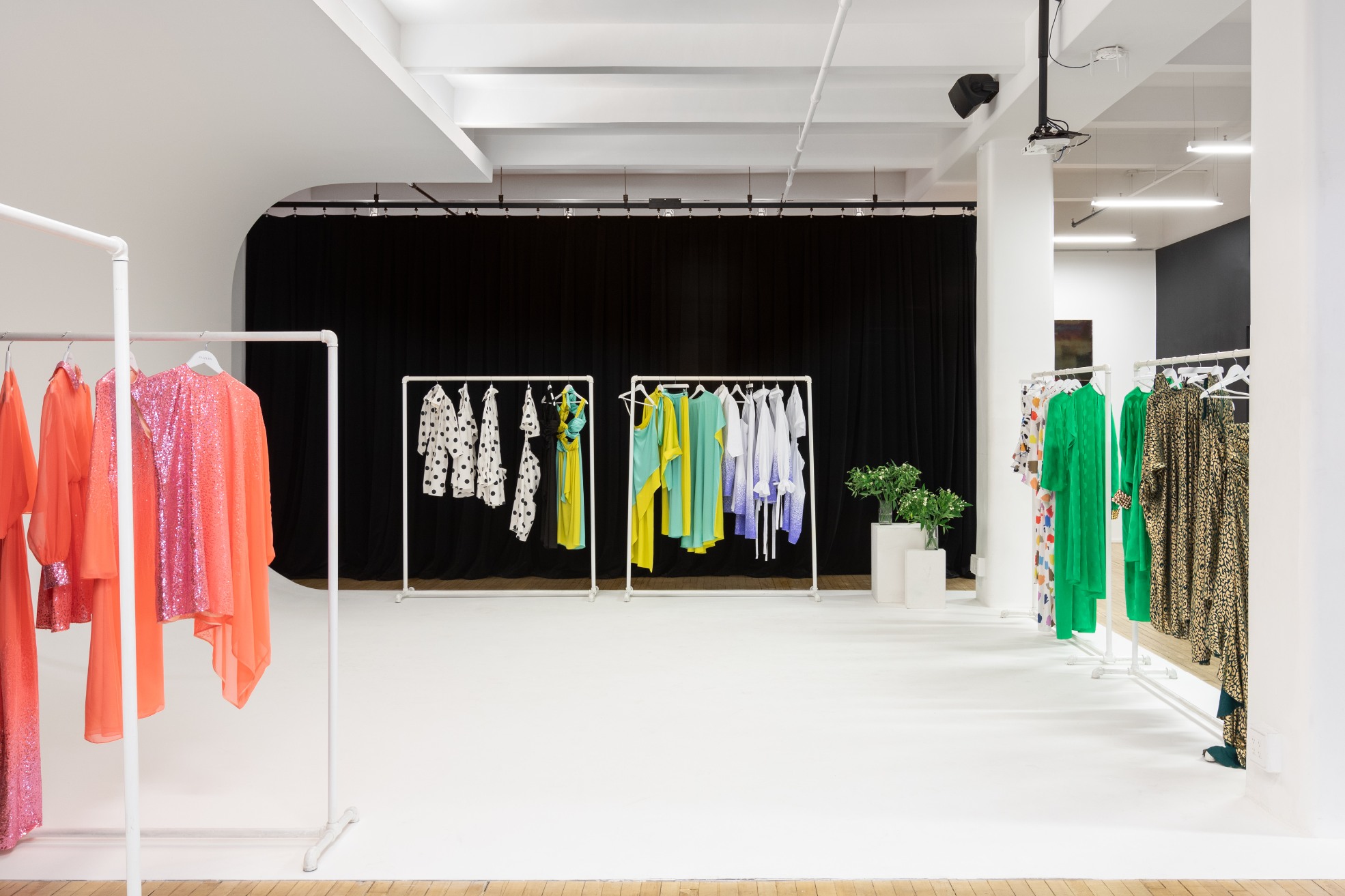 cocoon avedon colorful clothes on racks white studio