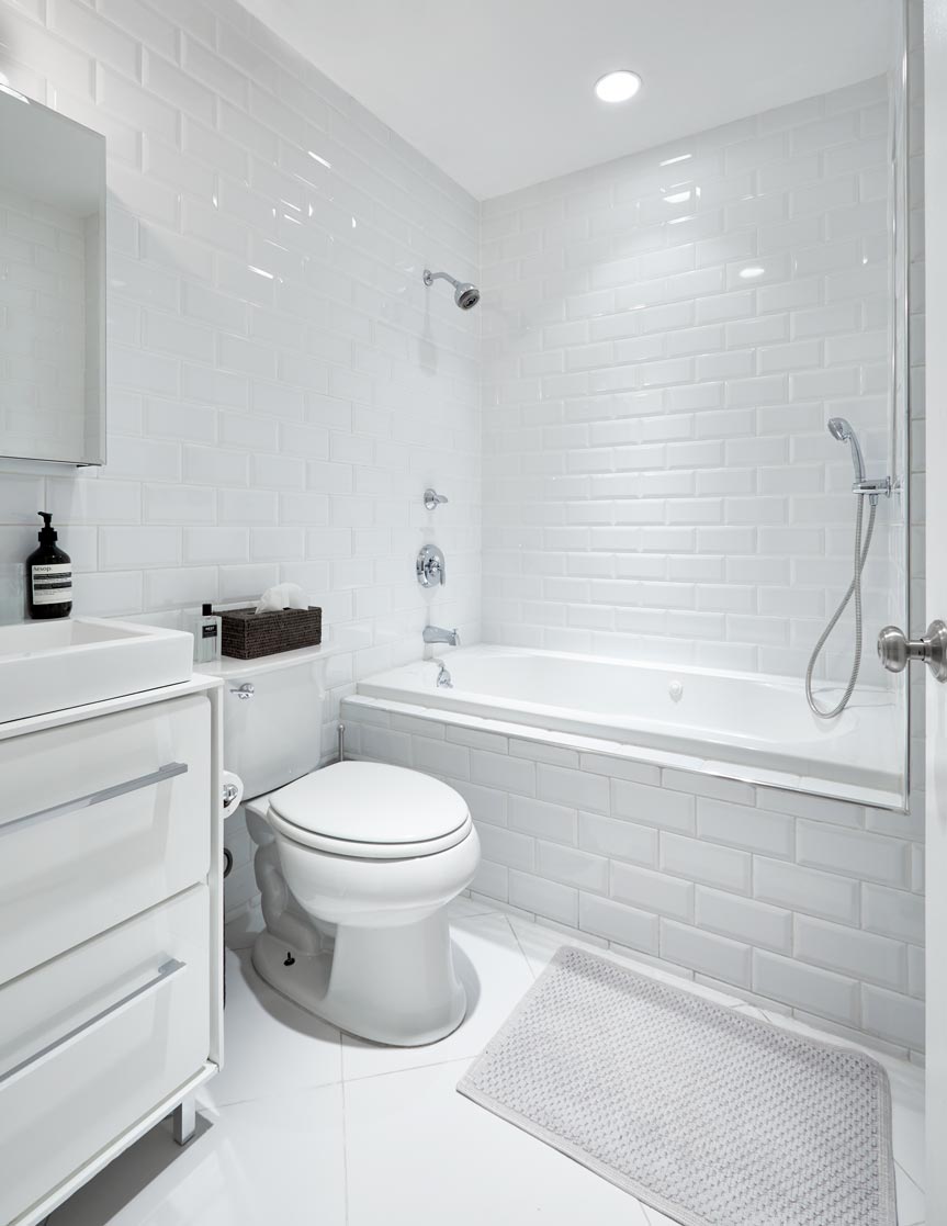 cocoon boto Bathroom with white tile walls deep soaking bathtub and rainfall shower