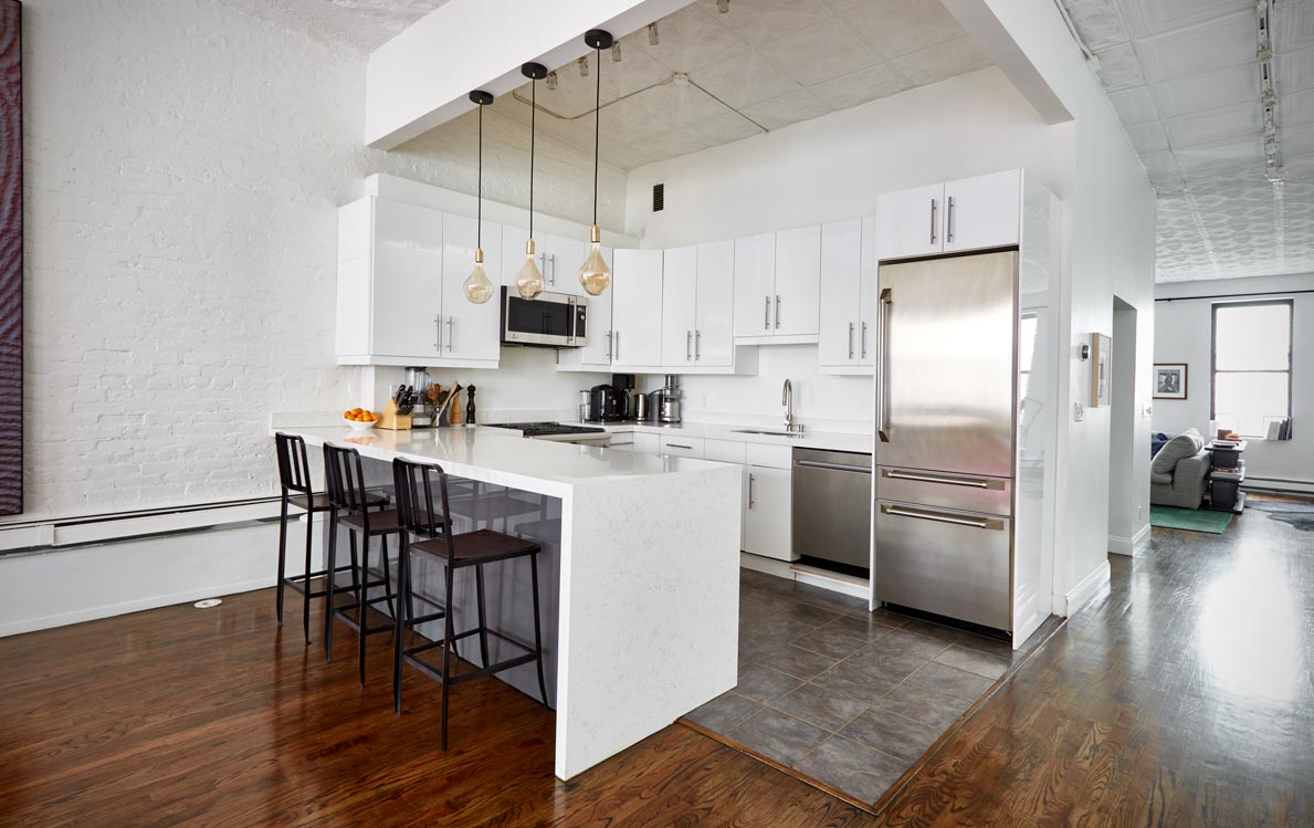 cocoon boto First floor kitchen with hanging lights white cabinetry and black counter stools
