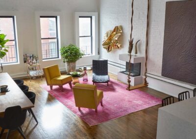 cocoon boto Living room with with swing pink rug glass fireplace unique art and plants