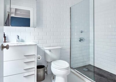 cocoon boto Second bathroom with standing glass shower and white tile walls