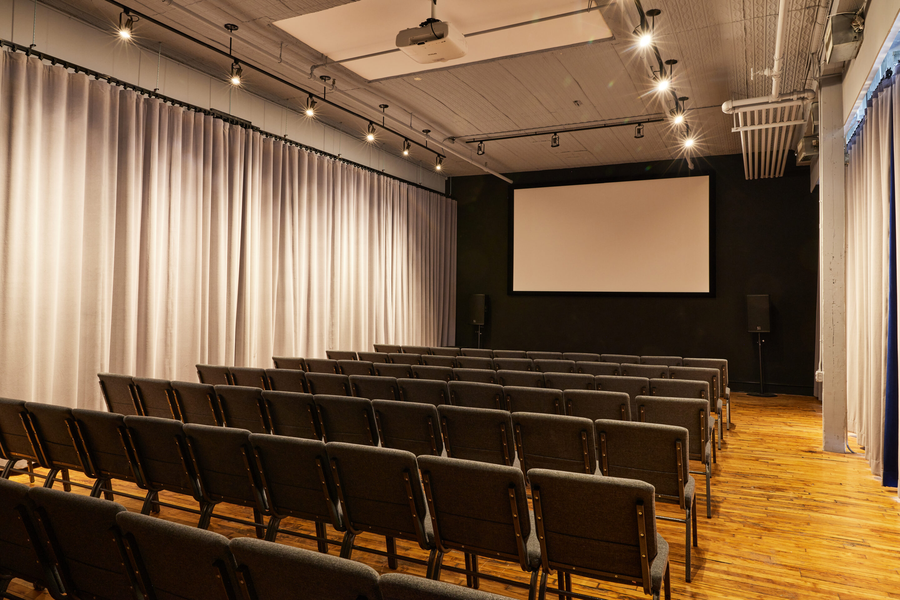 Casa Kino event space with chairs and projector screen
