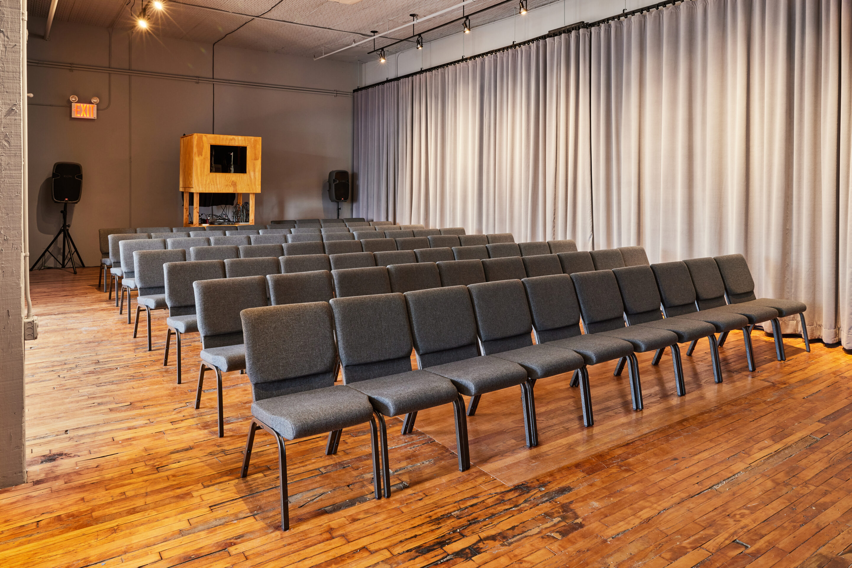 Casa Kino Event Space with rows of chairs and projector