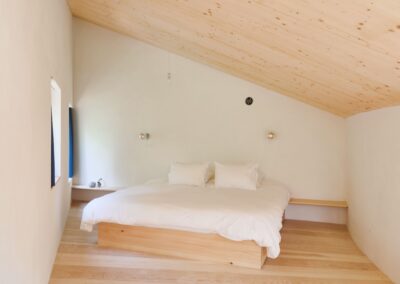 12 Casa Cometa Space Rental Interior Guest Bedroom Loft Suite with king size bed and pinewood floors and mass timber spruce ceilings