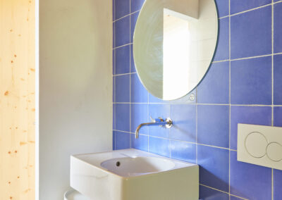 15 Casa Cometa Space Rental Interior Bathroom vertical with blue tiles and sink and kartell componibili storage