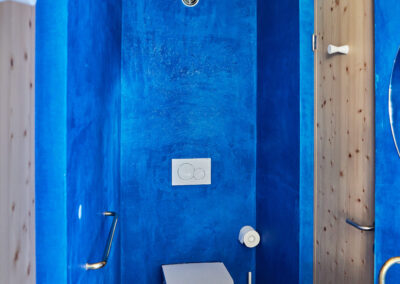 22 Casa Cometa Space Rental Interior Blue Jack and Jill Bathroom vertical with toilet and sink