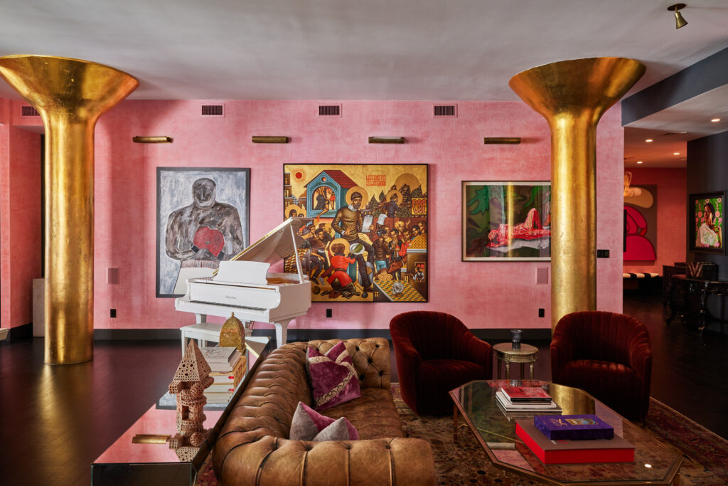 Casa Maxima 8 Living Space with Gold Columns, Wall Art, Grand Piano, and Pink Venetian Plaster Throughout