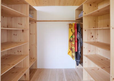 26 Casa Cometa Space Rental Interior Primary Bedroom walk in closet with built in pine plywood shelves