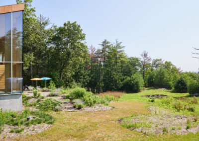 41 Casa Cometa Space Rental Exterior Backyard facing northeast with umbrellas and large grass field